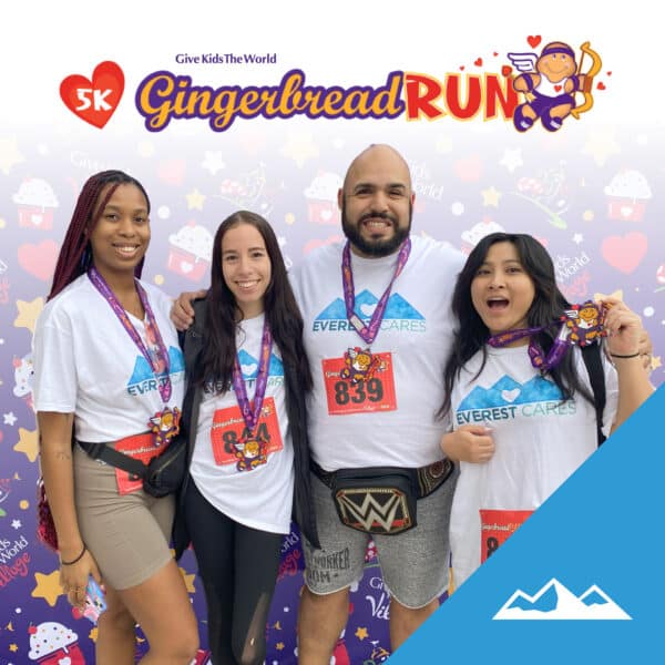 Everest employees wearing Everest Cares shirts and Gingerbread Run medals